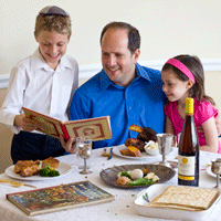 Father at home with kids at the Pesach table